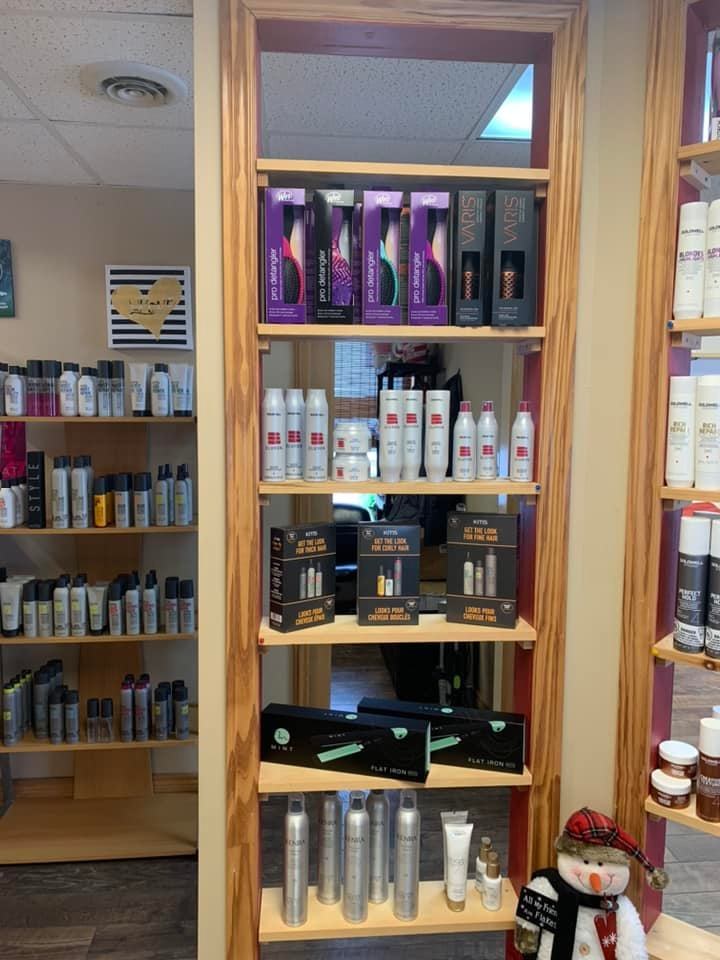 Wooden retail shelves at Maryjo's Hair Design stocked with professional styling products